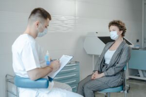 Adult patient meeting with a healthcare professional during a clinical evaluation in a modern medical office setting.